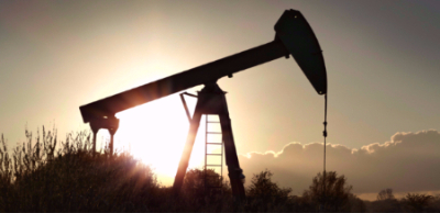 The silhouette of a fracking machine at sunset. 