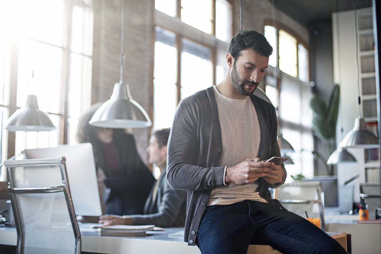 A business man looking at his phone.