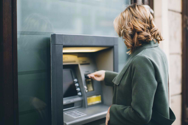 A woman getting money from an ATM.