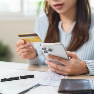 Woman using credit on her phone