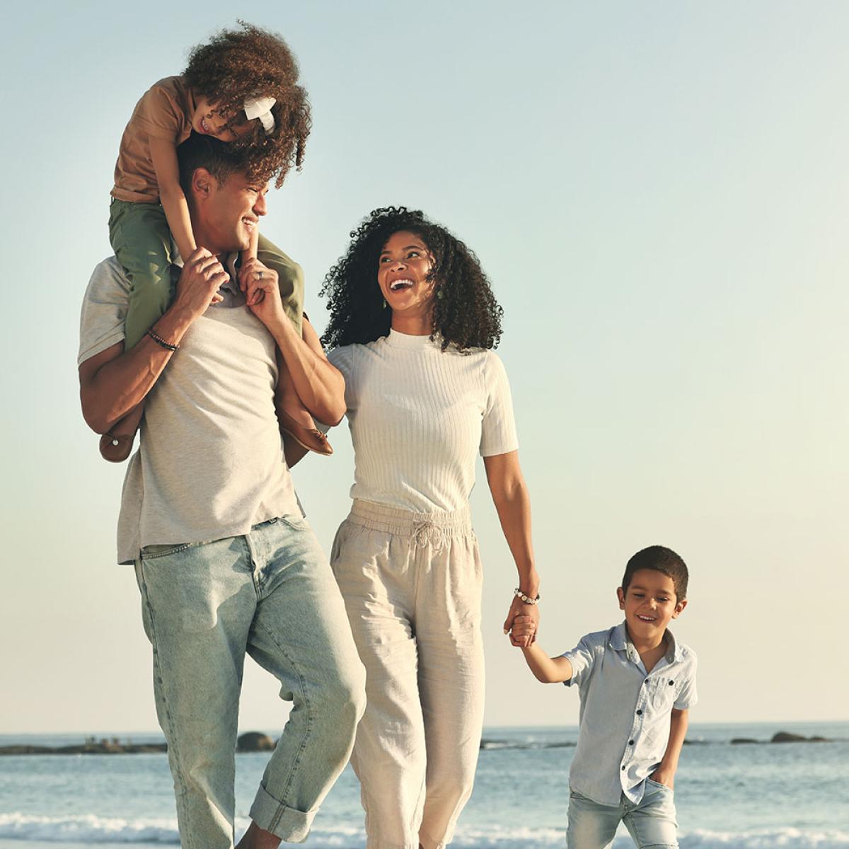 smiling family walking on the beach