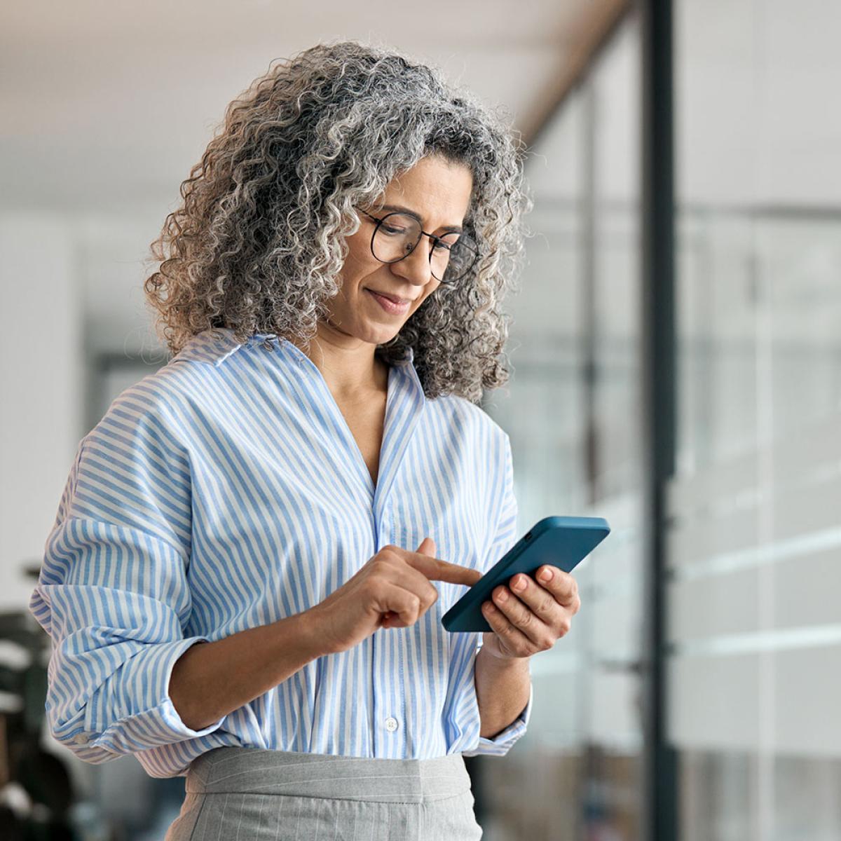lady with grey hair using mobile phone