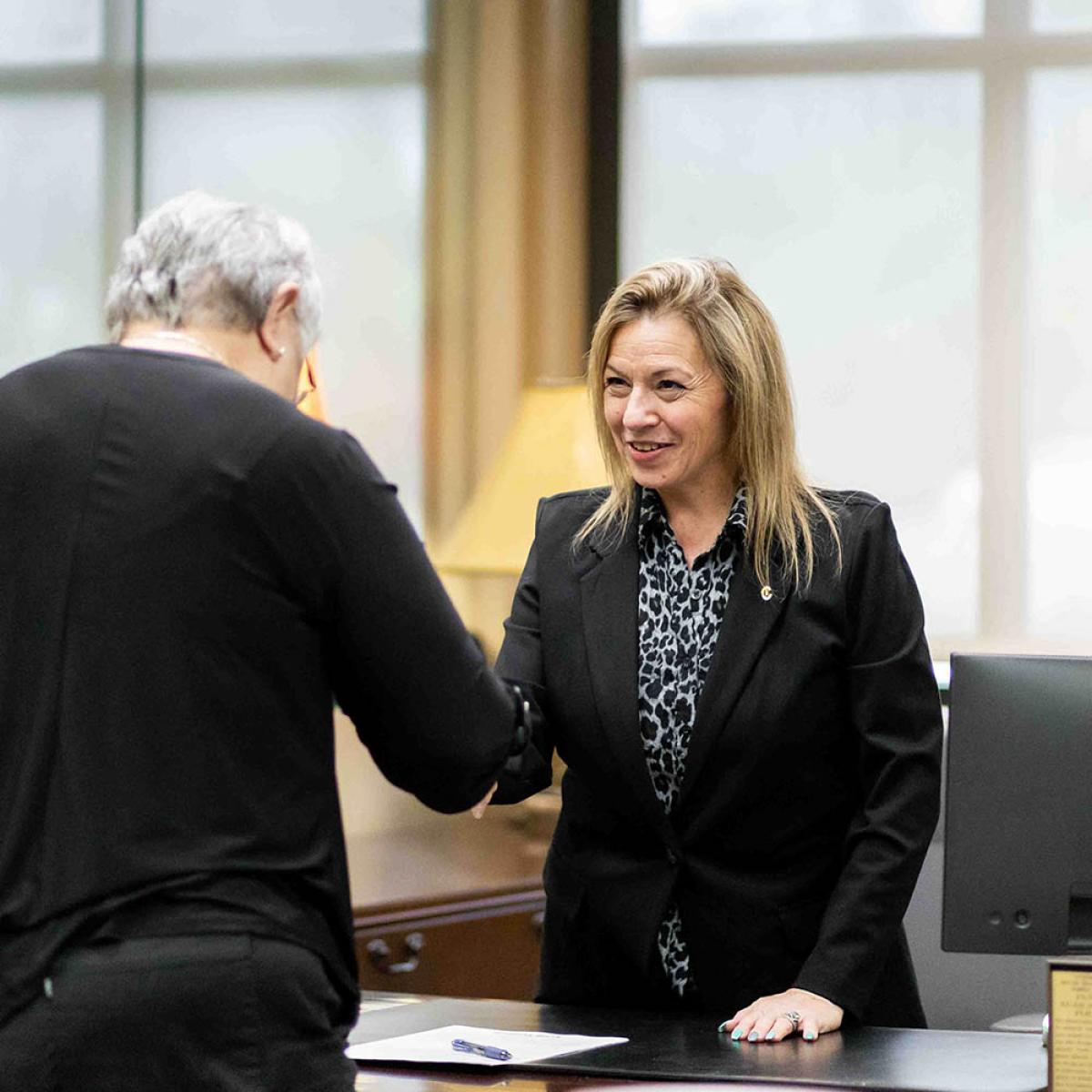 bank employee shaking customers hand