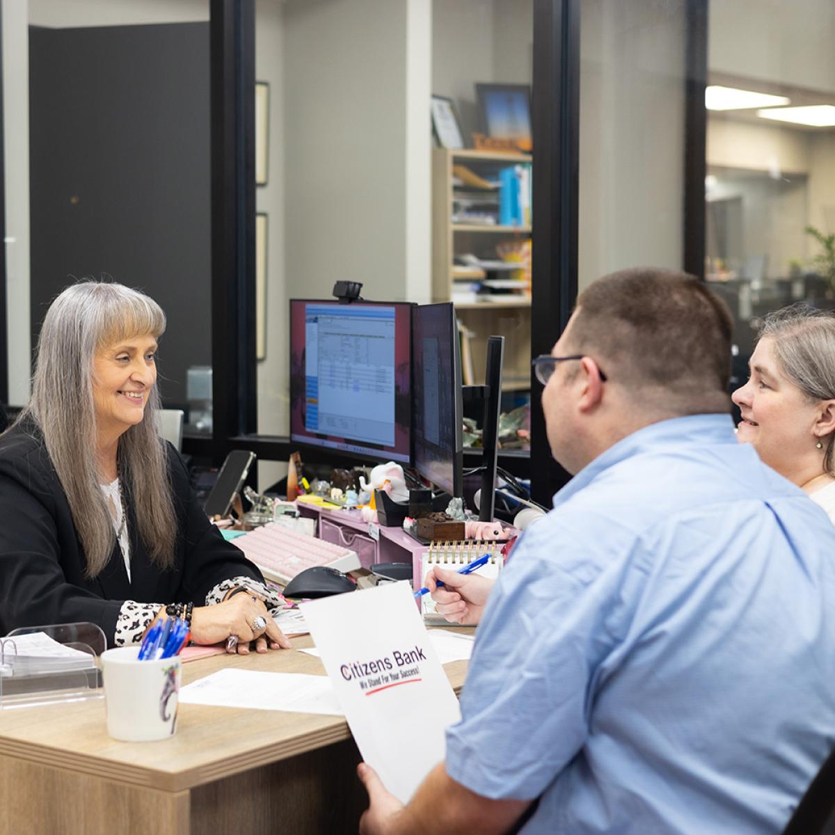bank employee shaking customers hand