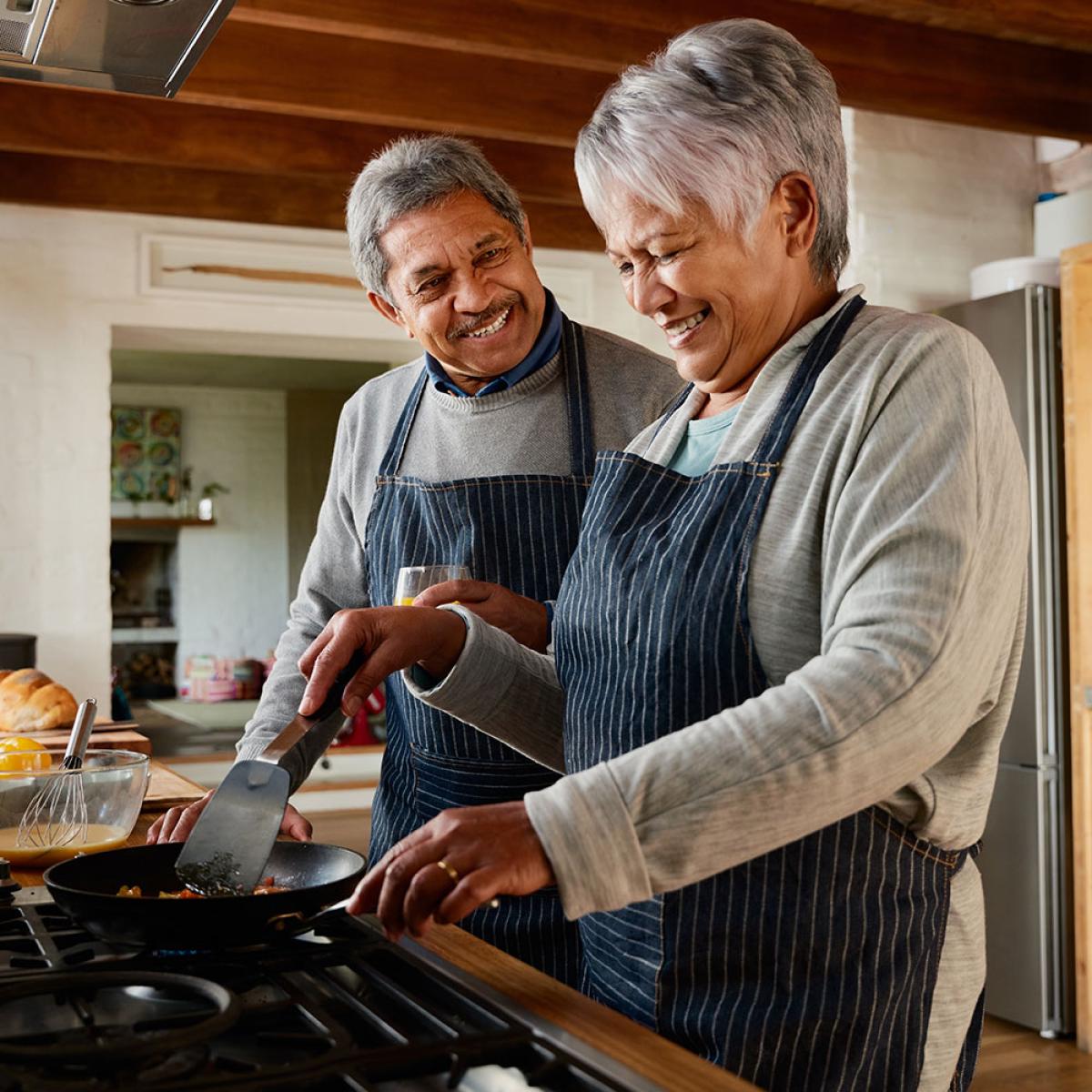 retired couple cooking at home