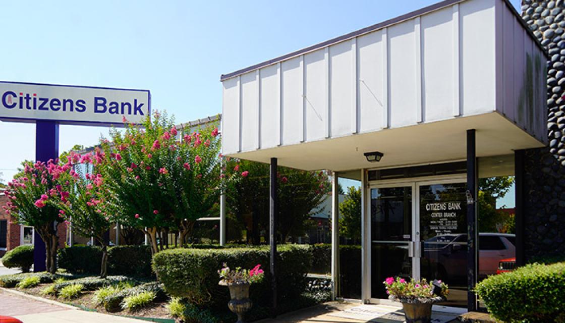 Entrance to white building with glass doors