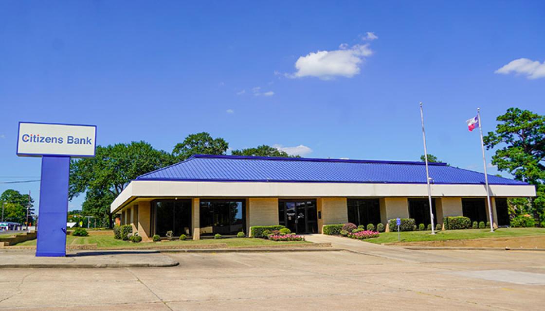Large tan building with blue roof